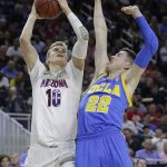 Arizona's Lauri Markkanen shoots over UCLA's TJ Leaf during the first half of an NCAA college basketball game in the semifinals of the Pac-12 men's tournament Friday, March 10, 2017, in Las Vegas. (AP Photo/John Locher)