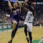 Phoenix Suns guard Devin Booker (1) goes up for a shot against Boston Celtics forward Jaylen Brown (7) during the first quarter of an NBA basketball game, Friday, March 24, 2017, in Boston. Booker scored 70 points, but the Celtics won 130-120. (AP Photo/Elise Amendola)