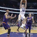 Charlotte Hornets' Cody Zeller (40) dunks against Phoenix Suns' Devin Booker (1) and Alex Len (21) in the first half of an NBA basketball game in Charlotte, N.C., Sunday, March 26, 2017. (AP Photo/Chuck Burton)