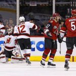 Arizona Coyotes right wing Radim Vrbata (17) celebrates his goal with defenseman Connor Murphy (5) as New Jersey Devils right wing Beau Bennett (8), defenseman Ben Lovejoy (12) and goalie Cory Schneider, second from left, all pause on the ice during the first period of an NHL hockey game Saturday, March 11, 2017, in Glendale, Ariz. (AP Photo/Ross D. Franklin)