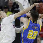 Arizona's Lauri Markkanen, left, fouls UCLA's TJ Leaf during the first half of an NCAA college basketball game in the semifinals of the Pac-12 men's tournament Friday, March 10, 2017, in Las Vegas. (AP Photo/John Locher)