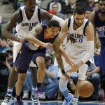 Phoenix Suns guard Tyler Ulis (8) and Dallas Mavericks center Salah Mejri (50) go for a loose ball during the second half of an NBA basketball game in Dallas, Saturday, March 11, 2017. The Suns defeated the Mavericks 100-98. (AP Photo/Michael Ainsworth)