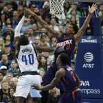 Dallas Mavericks forward Harrison Barnes (40) has a shot blocked by Phoenix Suns forward Marquese Chriss (0) as Eric Bledsoe (2) defends, during the second half of an NBA basketball game in Dallas, Saturday, March 11, 2017. The Suns defeated the Mavericks 100-98. (AP Photo/Michael Ainsworth)