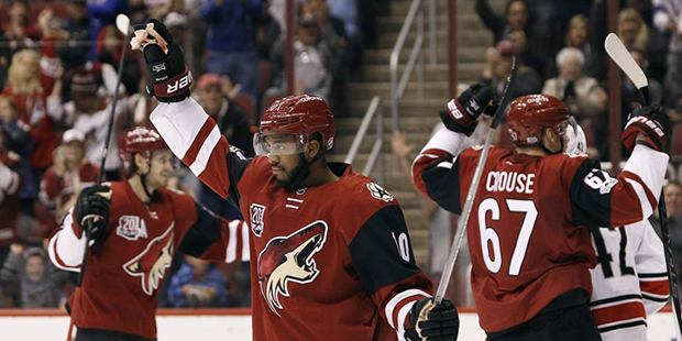 Arizona Coyotes winger Anthony Duclair (10) celebrates his assist on a goal by teammate Peter Holla...