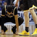 Wichita State's Landry Shamet is consoled by a teammate following a 65-62 loss to Kentucky in a second-round game in the men's NCAA college basketball tournament Sunday, March 19, 2017, in Indianapolis. (AP Photo/Jeff Roberson)