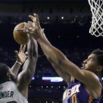 Boston Celtics forward Jae Crowder, left, and Phoenix Suns forward Marquese Chriss (0) vie for a rebound in the first quarter of an NBA basketball game, Friday, March 24, 2017, in Boston. (AP Photo/Elise Amendola)