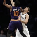 Brooklyn Nets' Brook Lopez, right, defends Phoenix Suns' Derrick Jones Jr. during the first half of an NBA basketball game Thursday, March 23, 2017, in New York. (AP Photo/Frank Franklin II)