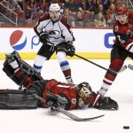Arizona Coyotes goalie Mike Smith, left, makes a diving save on a shot as Coyotes defenseman Luke Schenn (2) and Colorado Avalanche center Carl Soderberg (34) move in for the rebound during the first period of an NHL hockey game, Monday, March 13, 2017, in Glendale, Ariz. (AP Photo/Ross D. Franklin)