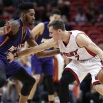 Miami Heat's Goran Dragic (7) drives to the basket as Phoenix Suns' Derrick Jones Jr. defends during the first half of an NBA basketball game, Tuesday, March 21, 2017, in Miami. (AP Photo/Lynne Sladky)