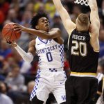 Kentucky's De'Aaron Fox (0) heads to the basket as Wichita State's Rauno Nurger defends during the second half of a second-round game in the men's NCAA college basketball tournament Sunday, March 19, 2017, in Indianapolis. Kentucky won 65-62. (AP Photo/Jeff Roberson)