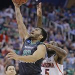 North Dakota guard Quinton Hooker (21) lays the ball up as Arizona guard Kadeem Allen (5) defends during the first half of a first-round men's college basketball game in the NCAA tournament Thursday, March 16, 2017, in Salt Lake City. (AP Photo/Rick Bowmer)