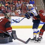 St. Louis Blues left wing Jaden Schwartz, middle, tries to hit the puck in the air as Alex Goligoski, right, defends and goalie Mike Smith, left, moves over to make a possible save during the second period of an NHL hockey game Saturday, March 18, 2017, in Glendale, Ariz. (AP Photo/Ross D. Franklin)
