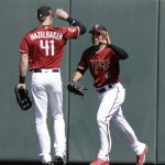 Arizona Diamondbacks' Gregor Blanco is congratulated by Jeremy Hazelbaker (41) after Blanco made a catch on a ball hit by Oakland Athletics' Matt Joyce during the first inning of a spring training baseball game, Tuesday, March 7, 2017, in Scottsdale, Ariz. (AP Photo/Darron Cummings)