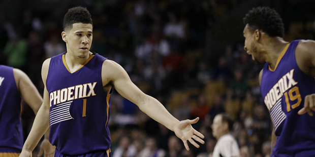 Phoenix Suns guard Devin Booker (1) is congratulated by guard Leandro Barbosa (19) in the fourth qu...