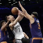 Brooklyn Nets' Jeremy Lin, center, drives between Phoenix Suns' Leandro Barbosa, left, and Jared Dudley during the first half of an NBA basketball game Thursday, March 23, 2017, in New York. (AP Photo/Frank Franklin II)