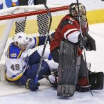 St. Louis Blues center Ivan Barbashev (49) ends up in the net after colliding with Arizona Coyotes goalie Mike Smith, right, during the first period of an NHL hockey game Saturday, March 18, 2017, in Glendale, Ariz. (AP Photo/Ross D. Franklin)