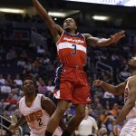 Washington Wizards guard Bradley Beal (3) drives past Phoenix Suns guard Eric Bledsoe (2) in the second quarter during an NBA basketball game, Tuesday, March 7, 2017, in Phoenix. (AP Photo/Rick Scuteri)