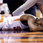 Phoenix Suns forward Derrick Jones Jr. is attended to after being hurt against the Sacramento Kings during the first half of an NBA basketball game, Wednesday, March 15, 2017, in Phoenix. (AP Photo/Matt York)