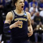 Michigan's D.J. Wilson celebrates during the second half of a second-round game against Louisville in the men's NCAA college basketball tournament Sunday, March 19, 2017, in Indianapolis. Michigan won 73-69. (AP Photo/Jeff Roberson)