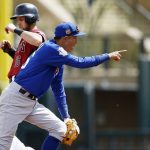 Chicago Cubs' Munenori Kawasaki, right, of Japan, points to first baseman Anthony Rizzo after a throw from Rizzo to Kawasaki was able to force out Arizona Diamondbacks' Chris Owings, left, at second base during the first inning of a spring training baseball game Thursday, March 23, 2017, in Scottsdale, Ariz. (AP Photo/Ross D. Franklin)