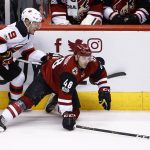 Arizona Coyotes left wing Jordan Martinook (48) falls to the ice as he tries to keep the puck away from New Jersey Devils left wing Taylor Hall (9) during the second period of an NHL hockey game Saturday, March 11, 2017, in Glendale, Ariz. (AP Photo/Ross D. Franklin)