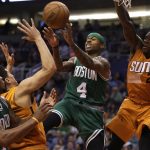 Boston Celtics guard Isaiah Thomas (4) passes between Phoenix Suns guard Devin Booker and Eric Bledsoe (2) in the fourth quarter during an NBA basketball game, Sunday, March 5, 2017, in Phoenix. Phoenix defeated Boston 109-106. (AP Photo/Rick Scuteri)
