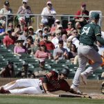 Arizona Diamondbacks' Gregor Blanco slides safe into home as Oakland Athletics' Sonny Gray covers during the first inning of a spring training baseball game, Tuesday, March 7, 2017, in Scottsdale, Ariz. (AP Photo/Darron Cummings)