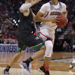 Arizona center Chance Comanche (21) looks to pass as North Dakota center Carson Shanks (5) defends during the first half of a first-round game in the NCAA men's college basketball tournament Thursday, March 16, 2017, in Salt Lake City. (AP Photo/George Frey)