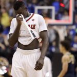 Louisville's Deng Adel walks off the court following a second-round game against Michigan in the men's NCAA college basketball tournament Sunday, March 19, 2017, in Indianapolis. Michigan won 73-69. (AP Photo/Jeff Roberson)