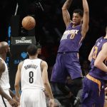Phoenix Suns' Marquese Chriss (0) dunks in front of Brooklyn Nets' Quincy Acy, left, and Spencer Dinwiddie, center, during the first half of an NBA basketball game Thursday, March 23, 2017, in New York. (AP Photo/Frank Franklin II)