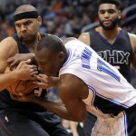 Orlando Magic center Bismack Biyombo (11) and Phoenix Suns forward Jared Dudley vie for the ball during the first half of an NBA basketball game, Friday, March 17, 2017, in Phoenix. (AP Photo/Matt York)