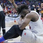 Southern Methodist forward Semi Ojeleye sits on the floor as Southern California celebrates at rear, following their first-round game in the men's NCAA college basketball tournament in Tulsa, Okla., Friday, March 17, 2017. Southern California won 66-65. (AP Photo/Sue Ogrocki)