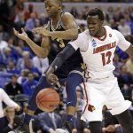 Louisville forward Mangok Mathiang (12) strips the ball from Michigan guard Xavier Simpson (3) during the first half of a second-round game in the men's NCAA college basketball tournament in Indianapolis, Sunday, March 19, 2017. (AP Photo/Michael Conroy)