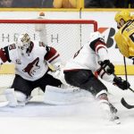 Arizona Coyotes goalie Mike Smith (41) blocks a shot as left wing Jordan Martinook (48) blocks out Nashville Predators left wing Cody McLeod (55) during the first period of an NHL hockey game Monday, March 20, 2017, in Nashville, Tenn. (AP Photo/Mark Humphrey)