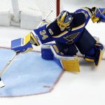St. Louis Blues goalie Jake Allen reaches for the puck as it slides by during the second period of an NHL hockey game against the Arizona Coyotes, Monday, March 27, 2017, in St. Louis. (AP Photo/Jeff Roberson)