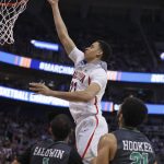 Arizona center Chance Comanche (21) lays the ball in as North Dakota guards Corey Baldwin (1) and Quinton Hooker (21) watch during the first half of a first-round game in the NCAA men's college basketball tournament Thursday, March 16, 2017, in Salt Lake City. (AP Photo/George Frey)