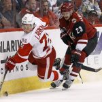 Detroit Red Wings center Dylan Larkin (71) gets tripped up by Arizona Coyotes defenseman Oliver Ekman-Larsson (23) during the second period of an NHL hockey game Thursday, March 16, 2017, in Glendale, Ariz. (AP Photo/Ross D. Franklin)