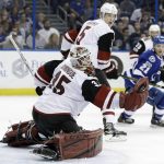 Arizona Coyotes goalie Louis Domingue (35) makes a glove save on a shot by Tampa Bay Lightning center Brayden Point (21) during the second period of an NHL hockey game Tuesday, March 21, 2017, in Tampa, Fla. (AP Photo/Chris O'Meara)