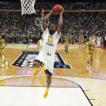 West Virginia forward Elijah Macon (45) drives to the basket for a slam dunk in the closing moments of their 83-71 victory against Notre Dame in a second-round men's college basketball game in the NCAA Tournament, Saturday, March 18, 2017, in Buffalo, N.Y. (AP Photo/Bill Wippert)