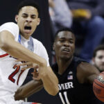 Arizona center Chance Comanche (21) works against Xavier guard Malcolm Bernard (11) during the first half of an NCAA Tournament college basketball regional semifinal game Thursday, March 23, 2017, in San Jose, Calif. (AP Photo/Tony Avelar)
