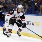 Arizona Coyotes' Christian Dvorak (18) controls the puck as St. Louis Blues' Colton Parayko watches during the first period of an NHL hockey game, Monday, March 27, 2017, in St. Louis. (AP Photo/Jeff Roberson)