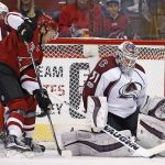 Colorado Avalanche goalie Calvin Pickard (31) makes a save on a shot as Arizona Coyotes right wing Tobias Rieder, second from left, looks for the rebound as Avalanche defenseman Tyson Barrie (4) arrives to help during the first period of an NHL hockey game, Monday, March 13, 2017, in Glendale, Ariz. (AP Photo/Ross D. Franklin)