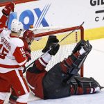 Arizona Coyotes goalie Mike Smith, right, gives up a goal to Detroit Red Wings' Dylan Larkin as Red Wings' Riley Sheahan (15) and Coyotes' defenseman Alex Goligoski (33) look on during the first period of an NHL hockey game Thursday, March 16, 2017, in Glendale, Ariz. (AP Photo/Ross D. Franklin)