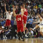 Villanova guard Jalen Brunson (1) follows through on a final shot as Wisconsin players celebrate the end of their second-round men's college basketball game in the NCAA Tournament, Saturday, March 18, 2017, in Buffalo, N.Y. (AP Photo/Bill Wippert)