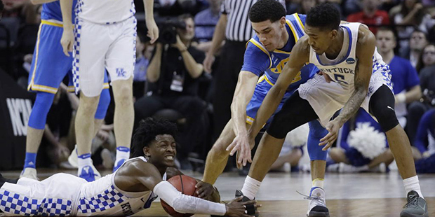 Kentucky guard De'Aaron Fox grabs the ball as UCLA guard Lonzo Ball and Kentucky guard Malik Monk l...
