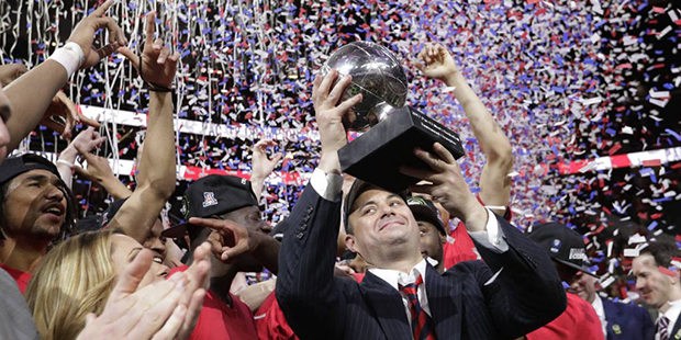 Arizona coach Sean Miller holds up the trophy after Arizona defeated Oregon 83-80 in an NCAA colleg...