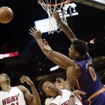 Phoenix Suns' Marquese Chriss (0) loses the ball as he is fouled by Miami Heat's Josh Richardson, center, during the first half of an NBA basketball game Tuesday, March 21, 2017, in Miami. (AP Photo/Lynne Sladky)