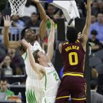 Oregon's Kavell Bigby-Williams, left, and Casey Benson, center, try to block a shot by Arizona State's Tra Holder during the first half of an NCAA college basketball game in the first round of the Pac-12 men's tournament Thursday, March 9, 2017, in Las Vegas. (AP Photo/John Locher)
