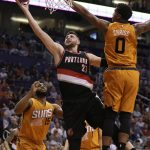 Portland Trail Blazers center Jusuf Nurkic (27) drives between Phoenix Suns' Alan Williams (15) and Marquese Chriss (0) during the first quarter of an NBA basketball game, Sunday, March 12, 2017, in Phoenix. (AP Photo/Rick Scuteri)