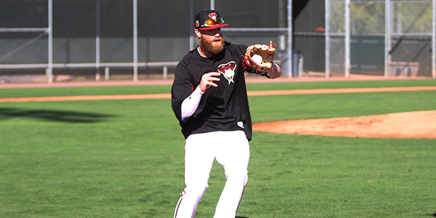 Arizona Diamondbacks pitcher Archie Bradley catches a ball on his way to first base during spring t...